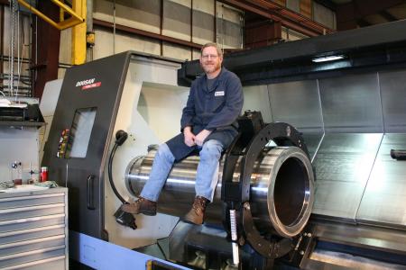 A Man Sitting On A Large Machine